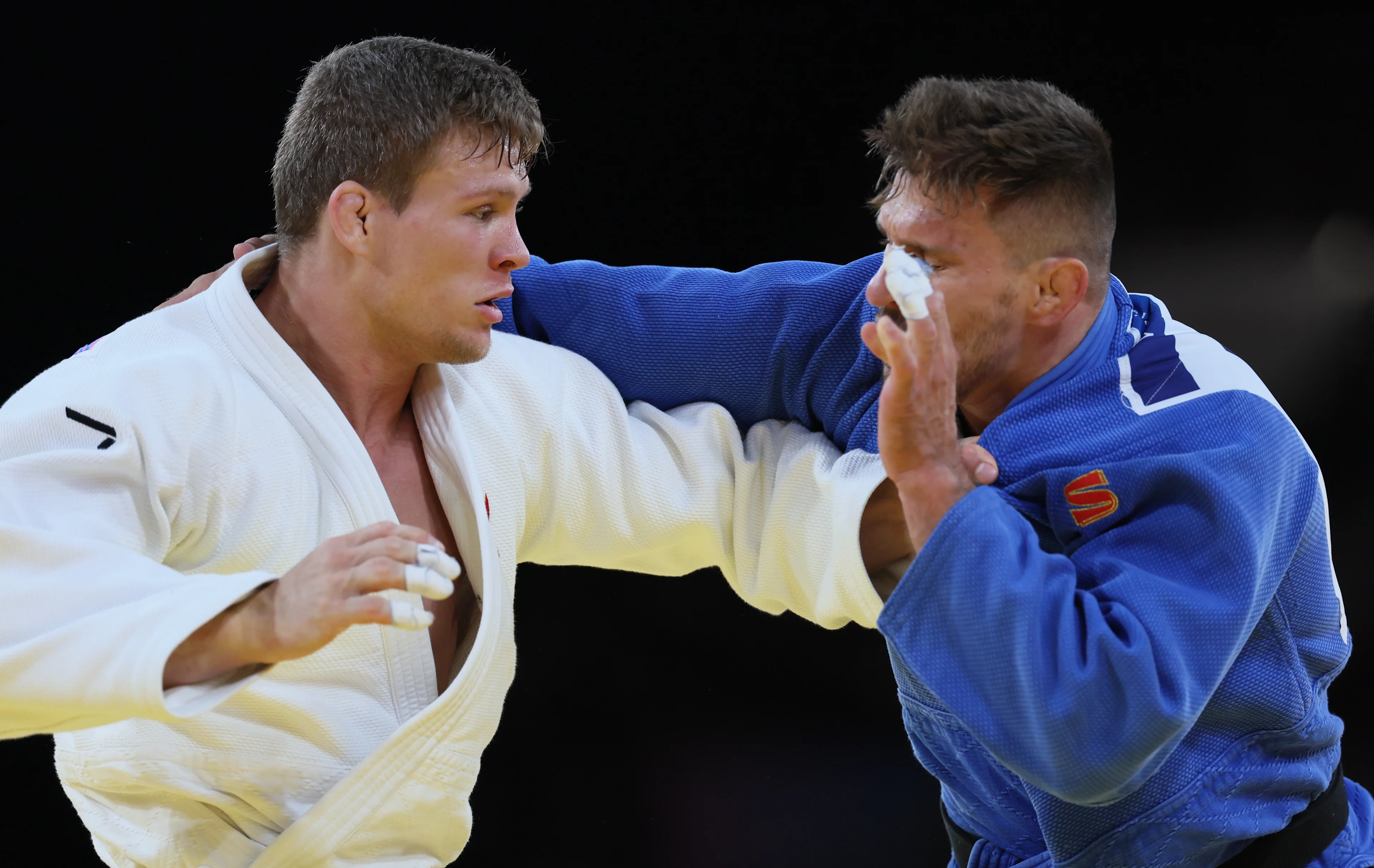 Belgian Matthias Casse (white gi) and Hungarian Attila Ungvari (blue gi) pictured in action during a judo bout in the elimination round of 16 of the -81kg category of the men's judo competition at the Paris 2024 Olympic Games, on Tuesday 30 July 2024 in Paris, France. The Games of the XXXIII Olympiad are taking place in Paris from 26 July to 11 August. The Belgian delegation counts 165 athletes competing in 21 sports. BELGA PHOTO BENOIT DOPPAGNE