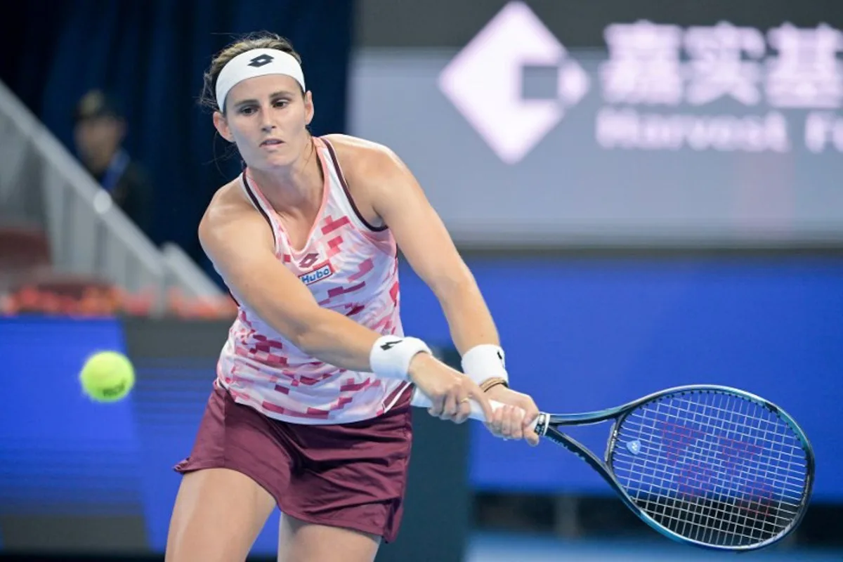 Belgium's Greet Minnen hits a return to China's Zhang Shuai during their women's singles match at the China Open tennis tournament in Beijing on September 29, 2024.  Jade Gao / AFP