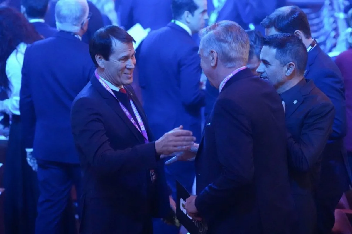 Belgium's French head coach Rudi Garcia (L) speaks with Brazil's Italian head coach Carlo Ancelotti (center R) as during the draw for the 2026 FIFA Football World Cup taking place in the US, Canada and Mexico, at the Kennedy Center, in Washington, DC, on December 5, 2025. Stephanie Scarbrough / POOL / AFP