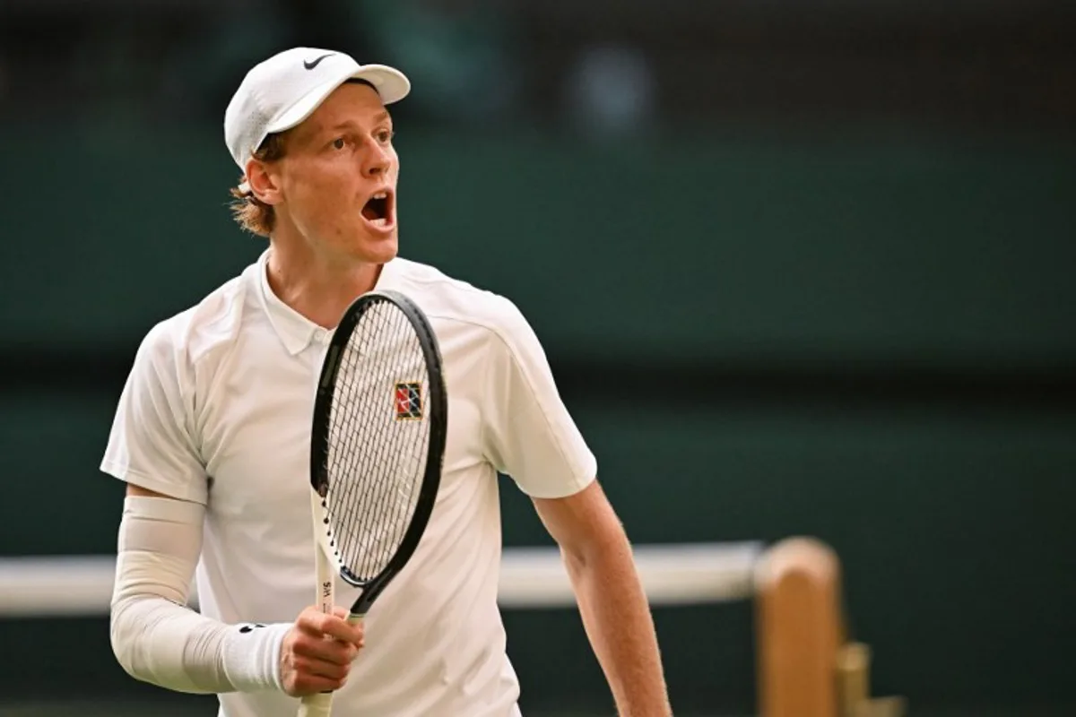 Italy's Jannik Sinner reacts as he plays against Spain's Carlos Alcaraz during their men's singles final tennis match on the fourteenth day of the 2025 Wimbledon Championships at The All England Lawn Tennis and Croquet Club in Wimbledon, southwest London, on July 13, 2025. Kirill KUDRYAVTSEV / AFP