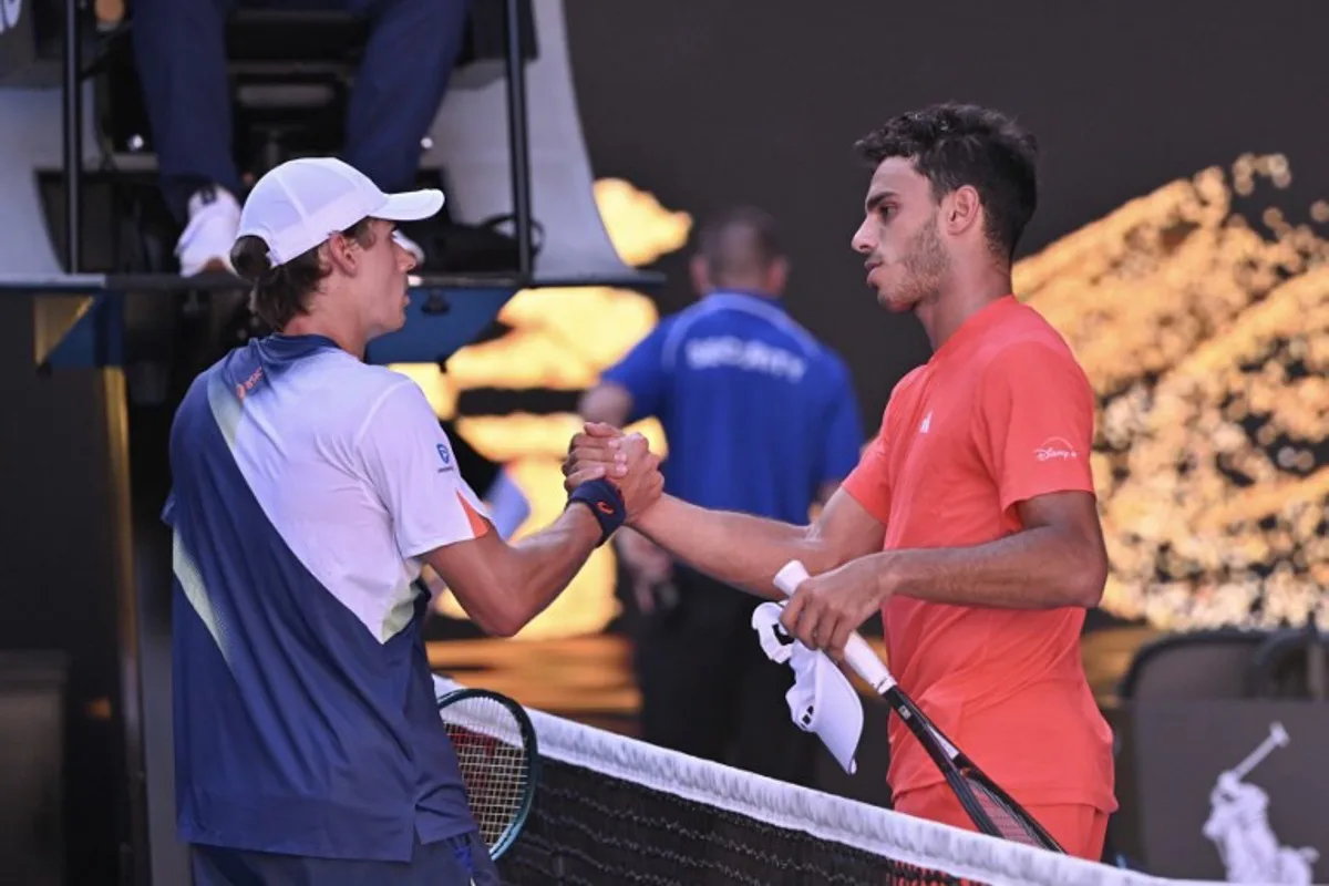 Australia's Alex De Minaur (L) and Argentina's Francisco Cerundolo shake hands at the net after their men's singles match on day seven of the Australian Open tennis tournament in Melbourne on January 18, 2025.  WILLIAM WEST / AFP