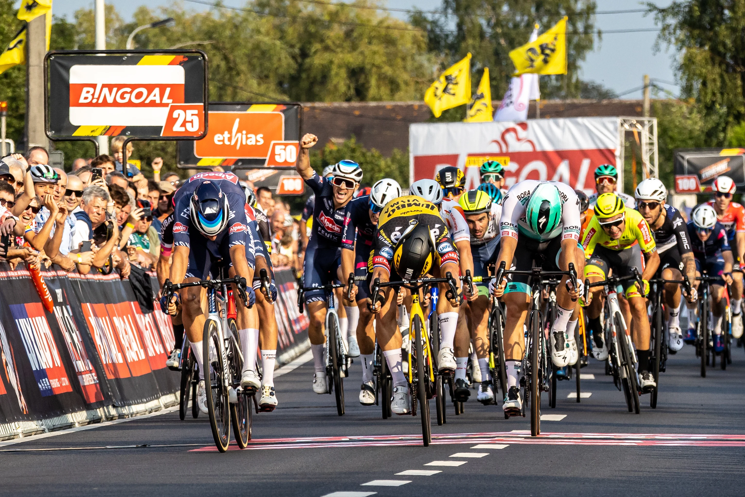 Belgian Jasper Philipsen of Alpecin-Fenix (L) wins before Dutch Dylan Groenewegen of Team Jumbo-Visma (C) and Estonian Martin Laas of Bora-Hansgrohe (R) the sprint at the finish of the 105th edition of the Kamioenschap van Vlaanderen one day cycling race, 195,3 km from Koolskamp to Koolskamp, Friday 17 September 2021, the eighth stage (out of 9) of the Bingoal cycling cup. BELGA PHOTO KURT DESPLENTER