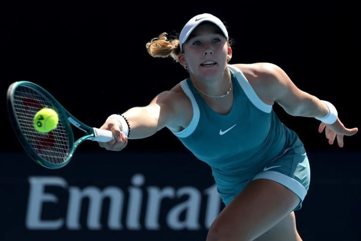 This handout picture released by the Tennis Australia on January 17, 2025 shows Russia's Mirra Andreeva hits a return against Poland's Magdalena Frech during their women's singles match at the Australian Open tennis tournament in Melbourne.   Hamish BLAIR / TENNIS AUSTRALIA / AFP