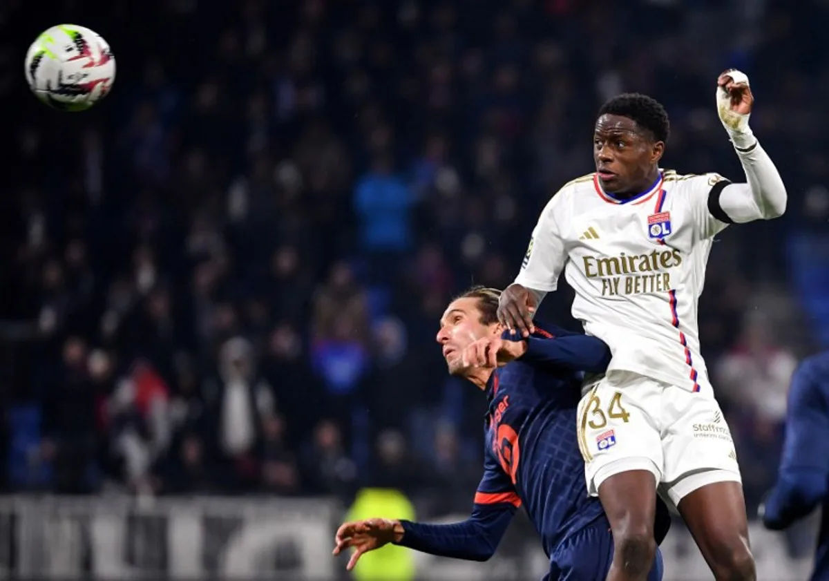 Lyon's French midfielder #34 Mahamadou Diawara (R) fights for the ball with Lille's Turkish midfielder #12 Yusuf Yazici (L) during the French L1 football match between Olympique Lyonnais (Lyon) and LOSC (Lille) at the Groupama stadium in Lyon, central eastern France on November 26, 2023. ARNAUD FINISTRE / AFP
