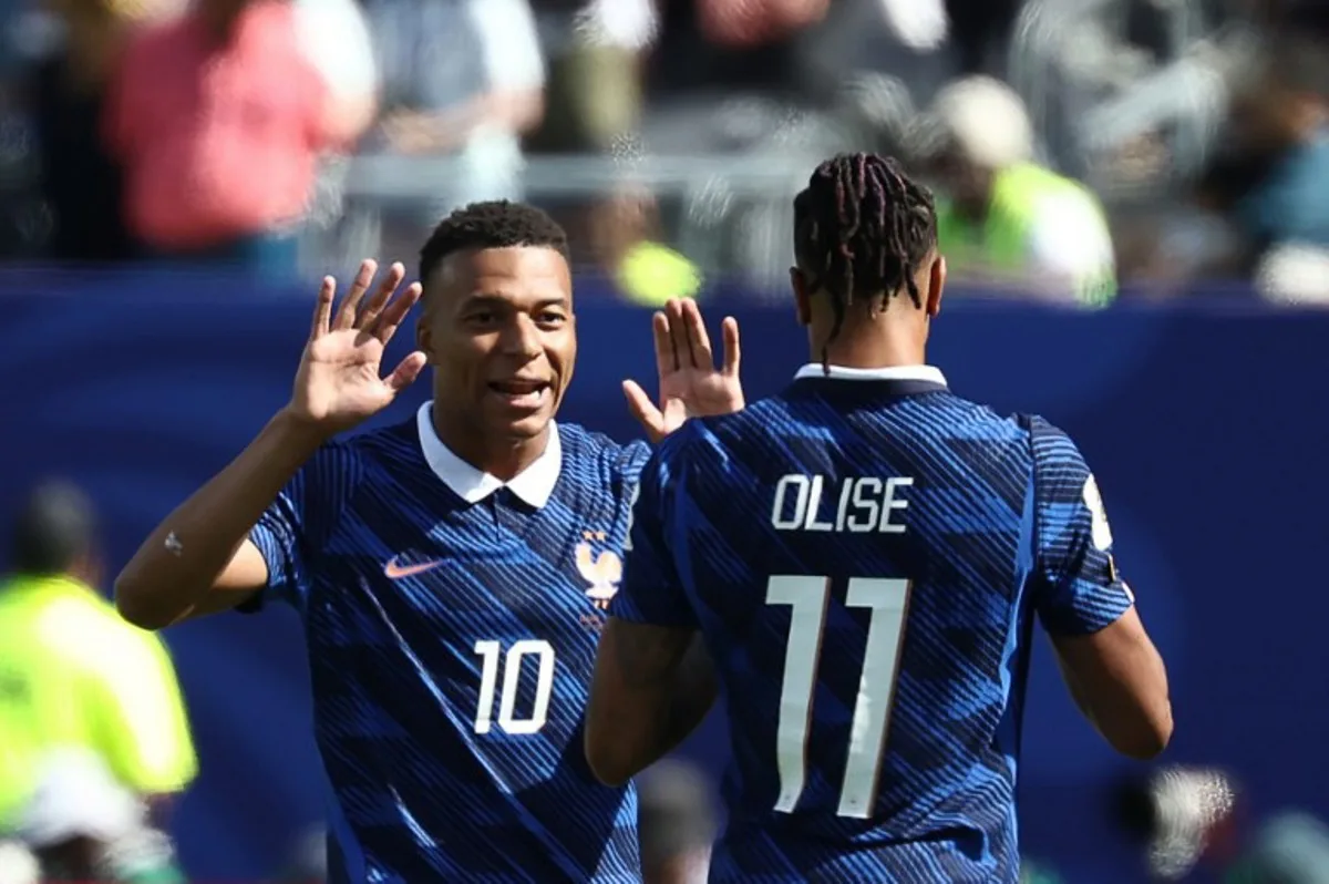 France's forward #10 Kylian Mbappe celebrates with teammate France's forward #11 Michael Olise after scoring his team's first goal during the 2026 World Cup Group I football match between France and Senegal at the New York/New Jersey Stadium in East Rutherford on June 16, 2026.   FRANCK FIFE / AFP
