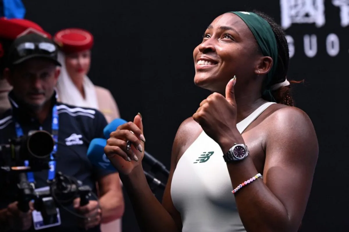 USA's Coco Gauff poses for a photo for fans after beating Switzerland's Belinda Bencic during their women's singles match on day eight of the Australian Open tennis tournament in Melbourne on January 19, 2025.  WILLIAM WEST / AFP