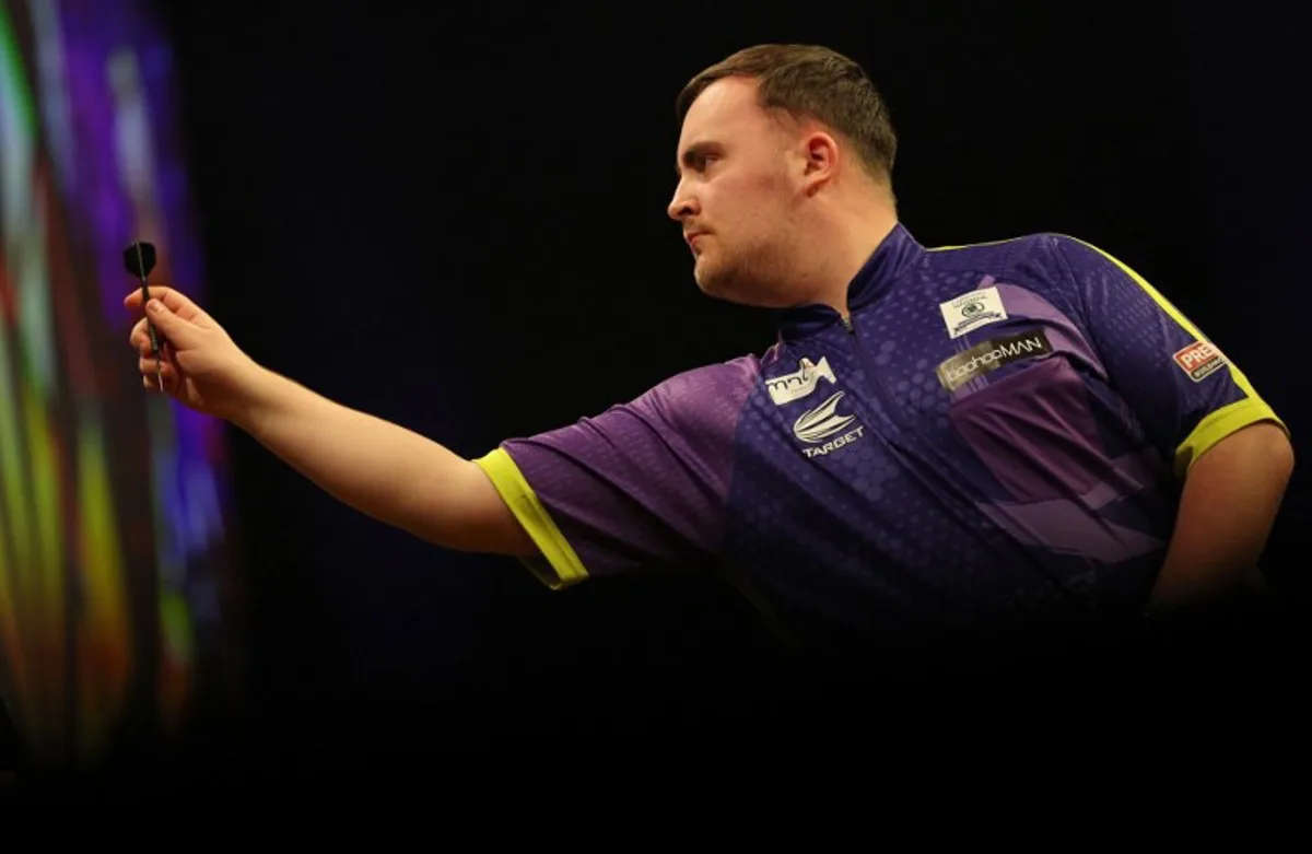 England's Luke Littler competes during his quarter-final darts match against England's Luke Humphries on Night 1 of the PDC Premier League, at the Utilita Arena in Cardiff, south Wales on February 1, 2024.  Adrian DENNIS / AFP