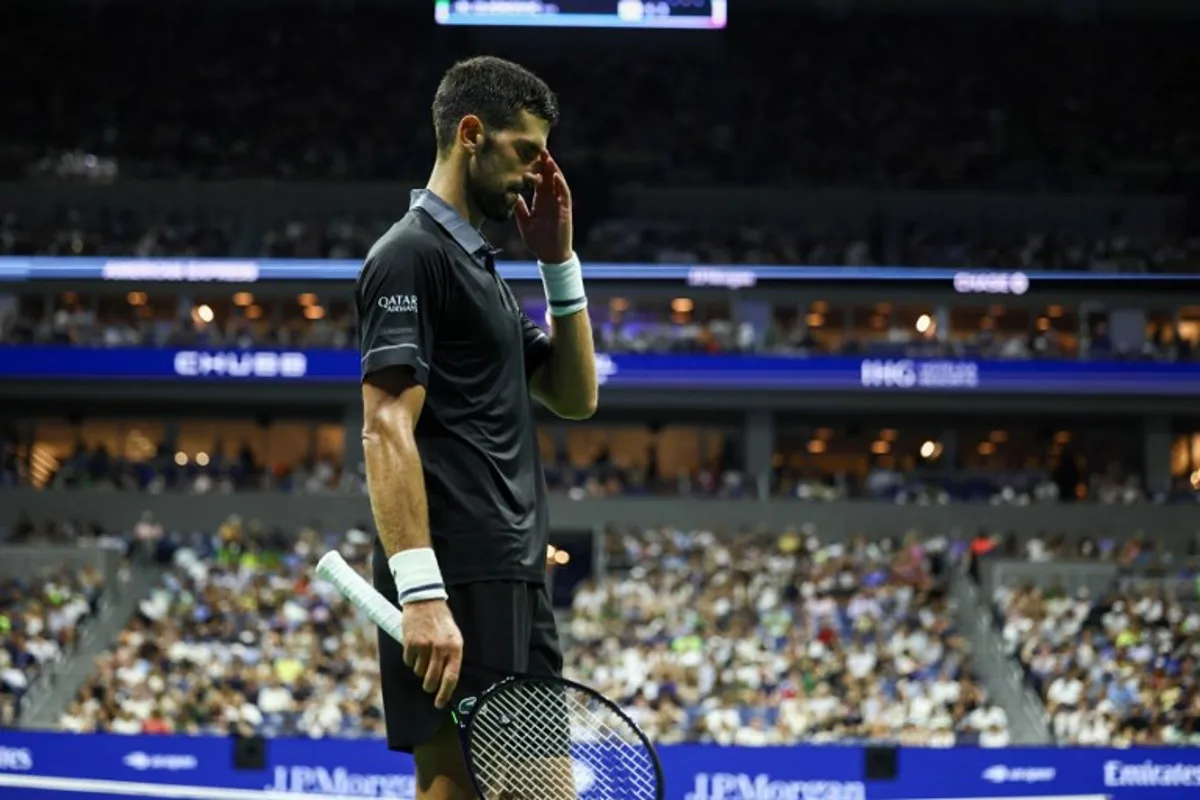 Serbia's Novak Djokovic reacts during a match against Argentina's Mariano Navone during the men's singles first round tennis match on day one of the US Open tennis tournament at the USTA Billie Jean King National Tennis Center in New York City on August 30, 2026.  CHARLY TRIBALLEAU / AFP