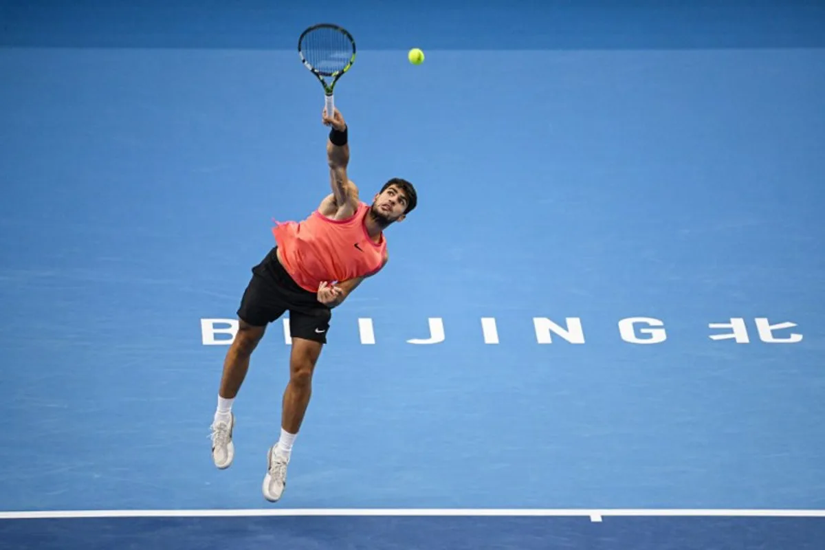 Spain's Carlos Alcaraz serves to Russia's Karen Khachanov during their men's singles quarter-final match at the China Open tennis tournament in Beijing on September 30, 2024.  GREG BAKER / AFP