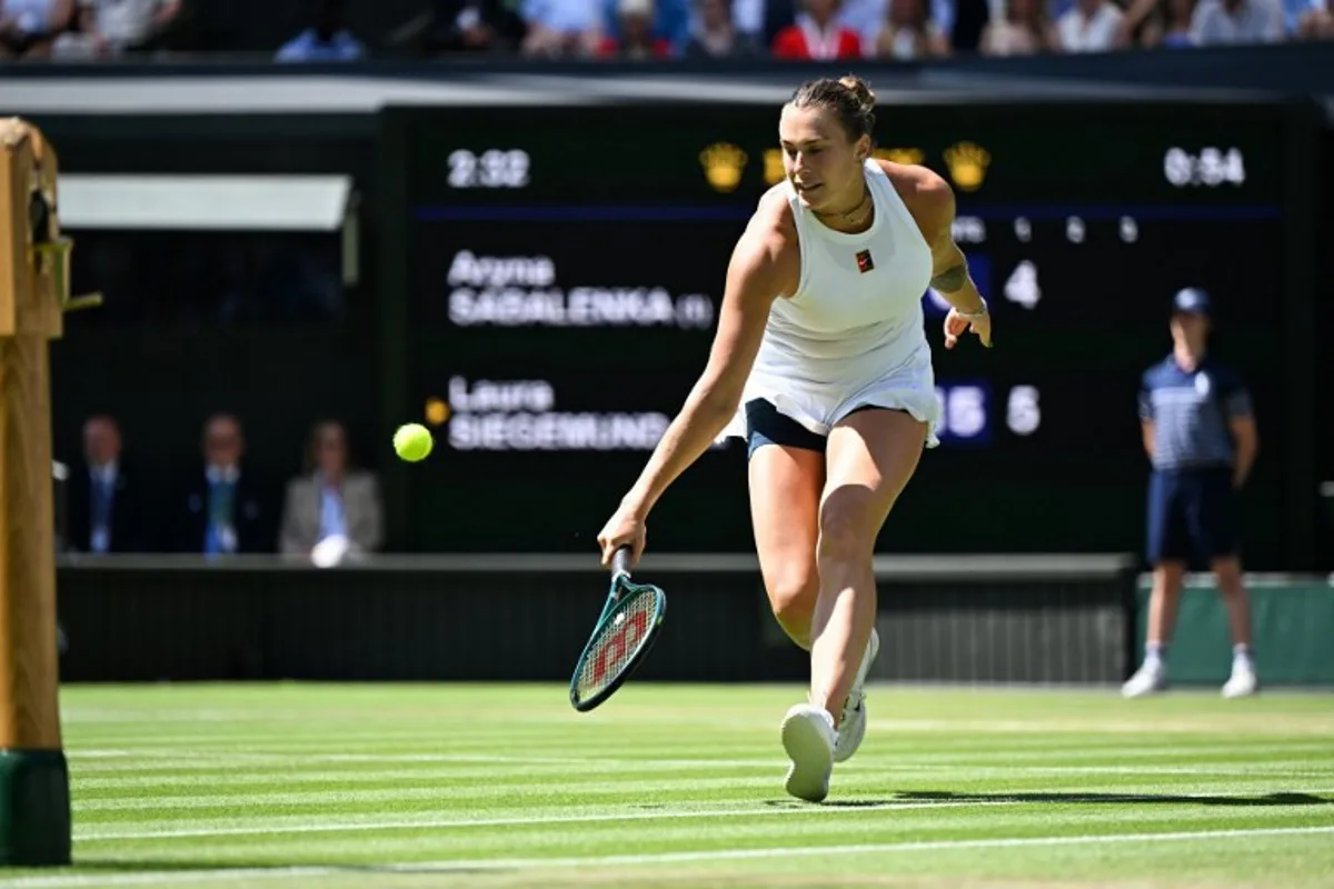Belarus's Aryna Sabalenka returns the ball to Germany's Laura Siegemund during their women's singles quarter-final tennis match on the ninth day of the 2025 Wimbledon Championships at The All England Lawn Tennis and Croquet Club in Wimbledon, southwest London, on July 8, 2025. Kirill KUDRYAVTSEV / AFP
