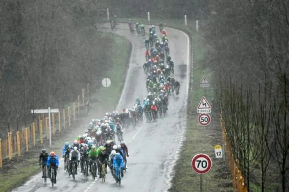 The pack rides in a heavy rain as they take the start of the 148,5km first stage of the 75th edition of the Paris-Nice cycling race, in and around Bois d'Arcy, near Paris on March 5, 2017.  Philippe LOPEZ / AFP