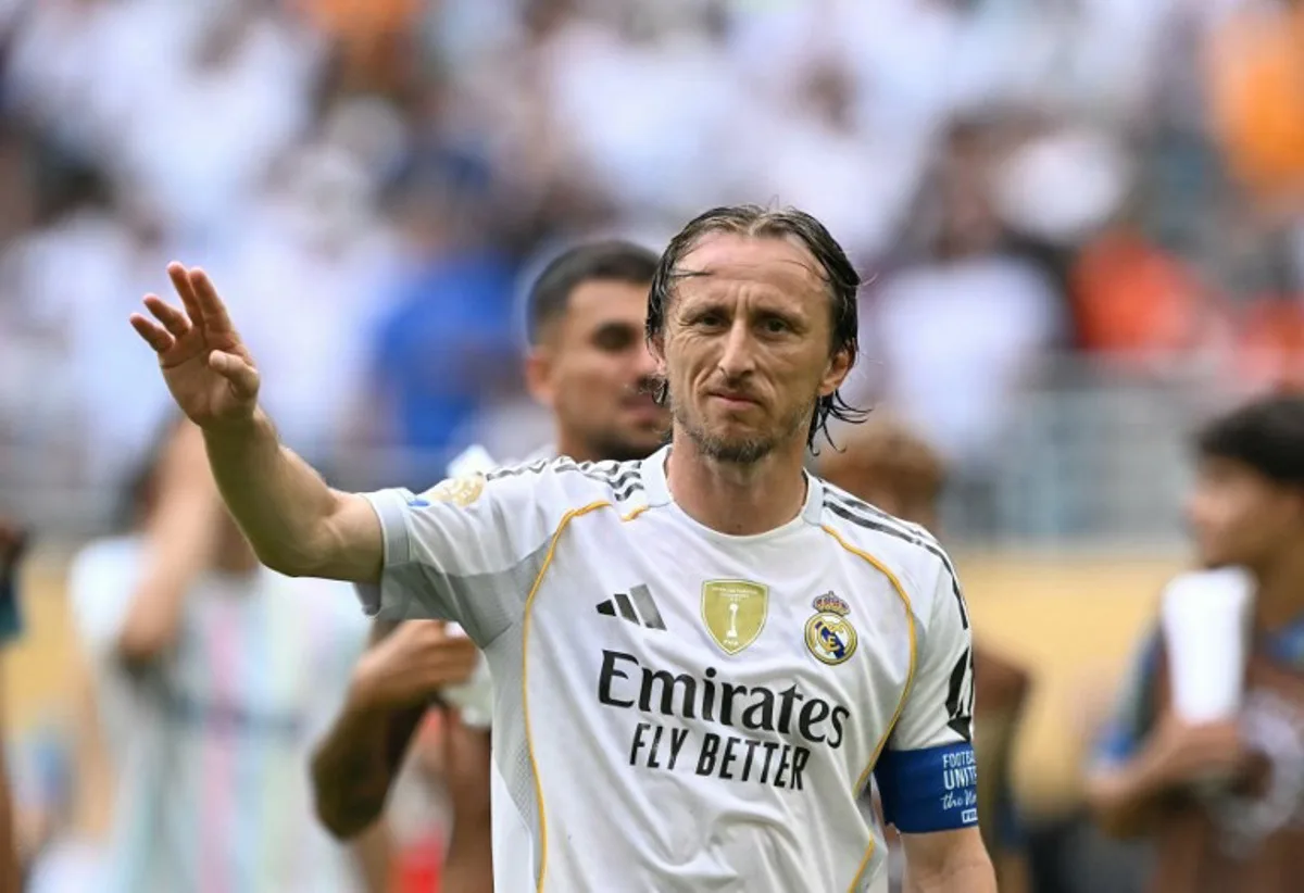 (FILES) Real Madrid's Croatian midfielder #10 Luka Modric greets fans after winning the FIFA Club World Cup 2025 round of 16 football match between Spain's Real Madrid and Italy's Juventus at the Hard Rock Stadium in Miami on July 1, 2025. AC Milan coach Massimiliano Allegri said on July 7, 2025, that Croatia's captain Luka Modric will join the Italian club from Real Madrid after the Club World Cup. Patricia DE MELO MOREIRA / AFP