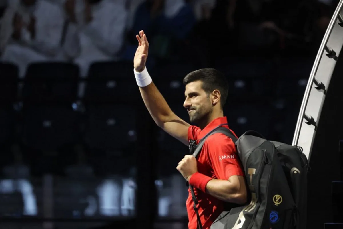 Serbia's Novak Djokovic greets fans ahead of the semi-final of the Six Kings Slam exhibition tennis tournament against Italy's Jannik Sinner in Riyadh on October 16, 2025. Fayez NURELDINE / AFP