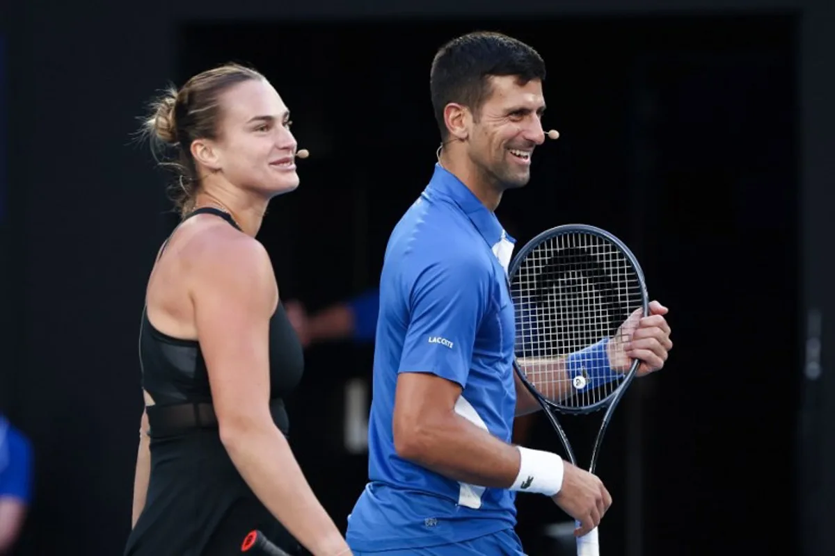 Aryna Sabalenka from Belarus and Serbia's Novak Djokovic play mixed-doubles together during a charity event on Rod Laver Arena in Melbourne on January 11, 2024 ahead of the Australian Open tennis championship starting on January 14.  DAVID GRAY / AFP