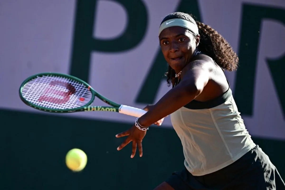 US Hailey Baptiste plays a forehand return to China's Wang Xiuy during their women's singles match on day 4 of the French Open tennis tournament at the Roland-Garros Complex in Paris on May 27, 2026. JULIEN DE ROSA / AFP