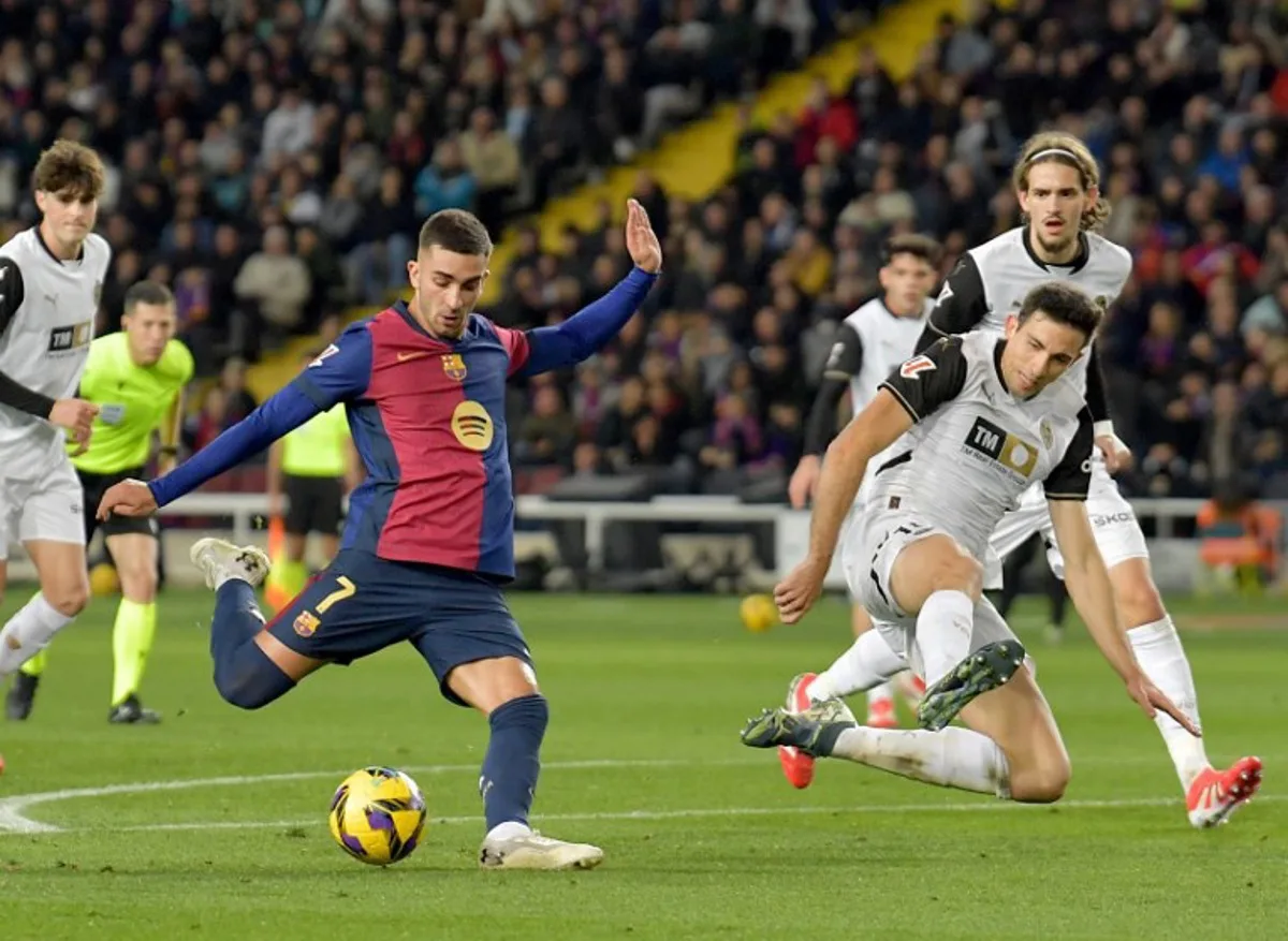 Barcelona's Spanish forward #07 Ferran Torres kicks the ball during the Spanish league football match between FC Barcelona and Valencia CF at the Estadi Olimpic Lluis Companys in Barcelona on January 26, 2025.  MANAURE QUINTERO / AFP