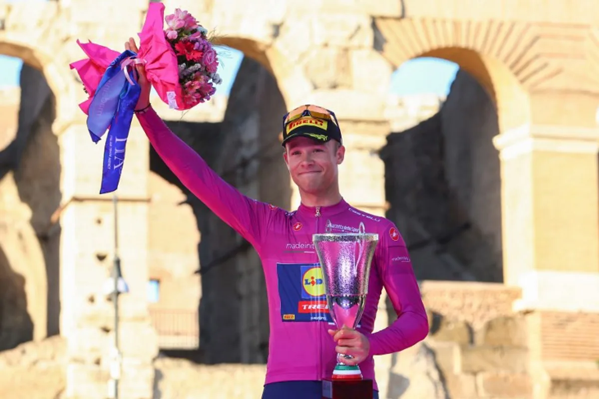 Team Lidl-Trek's Italian rider Jonathan Milan celebrates his best sprinter's purple (cyclamen) jersey on the podium in front of the Colosseum after the 21st and last stage of the 107th Giro d'Italia cycling race, 125km from Rome to Rome on May 26, 2024.  Luca Bettini / AFP