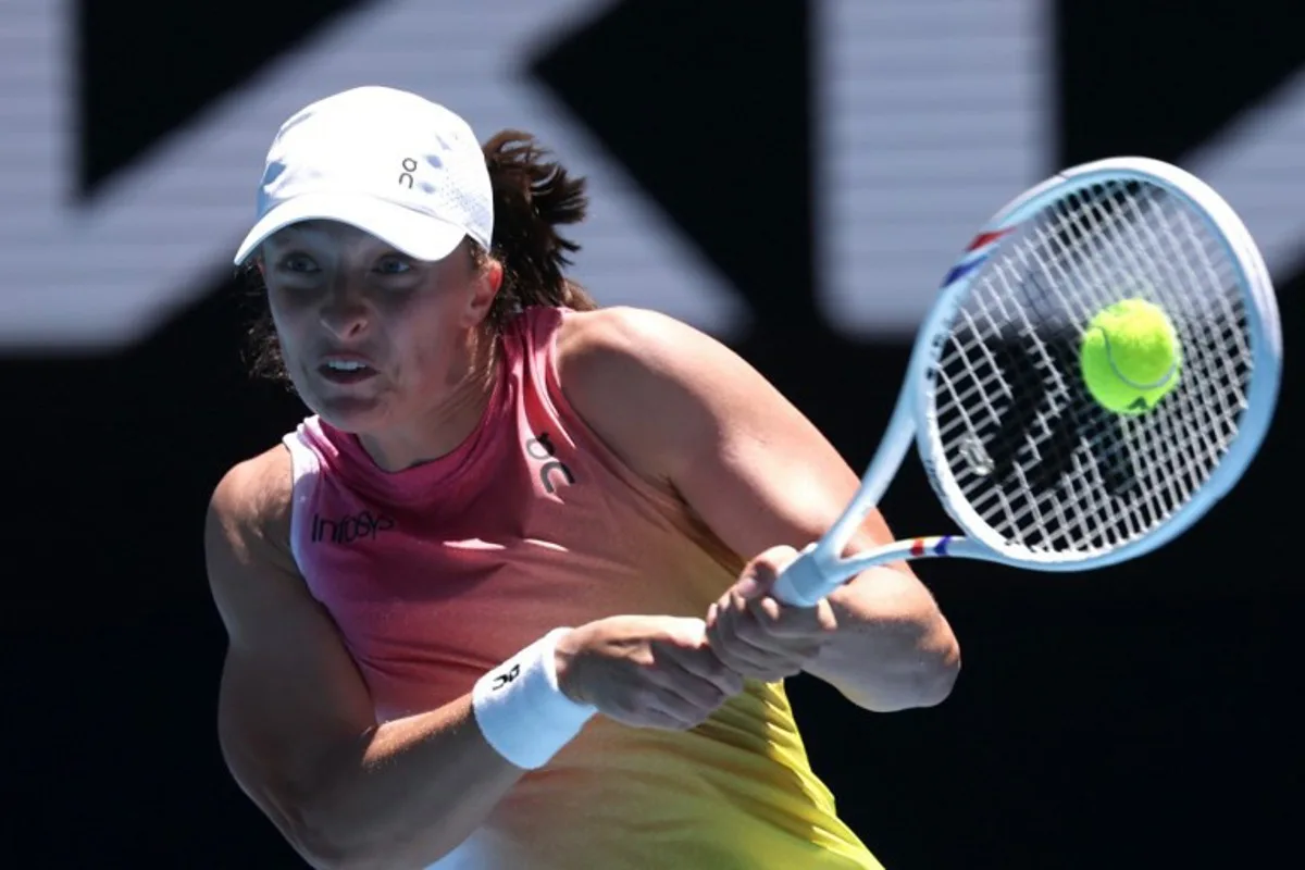 Poland's Iga Swiatek hits a return against Slovakia's Rebecca Sramkova during their women's singles match on day five of the Australian Open tennis tournament in Melbourne on January 16, 2025.  DAVID GRAY / AFP