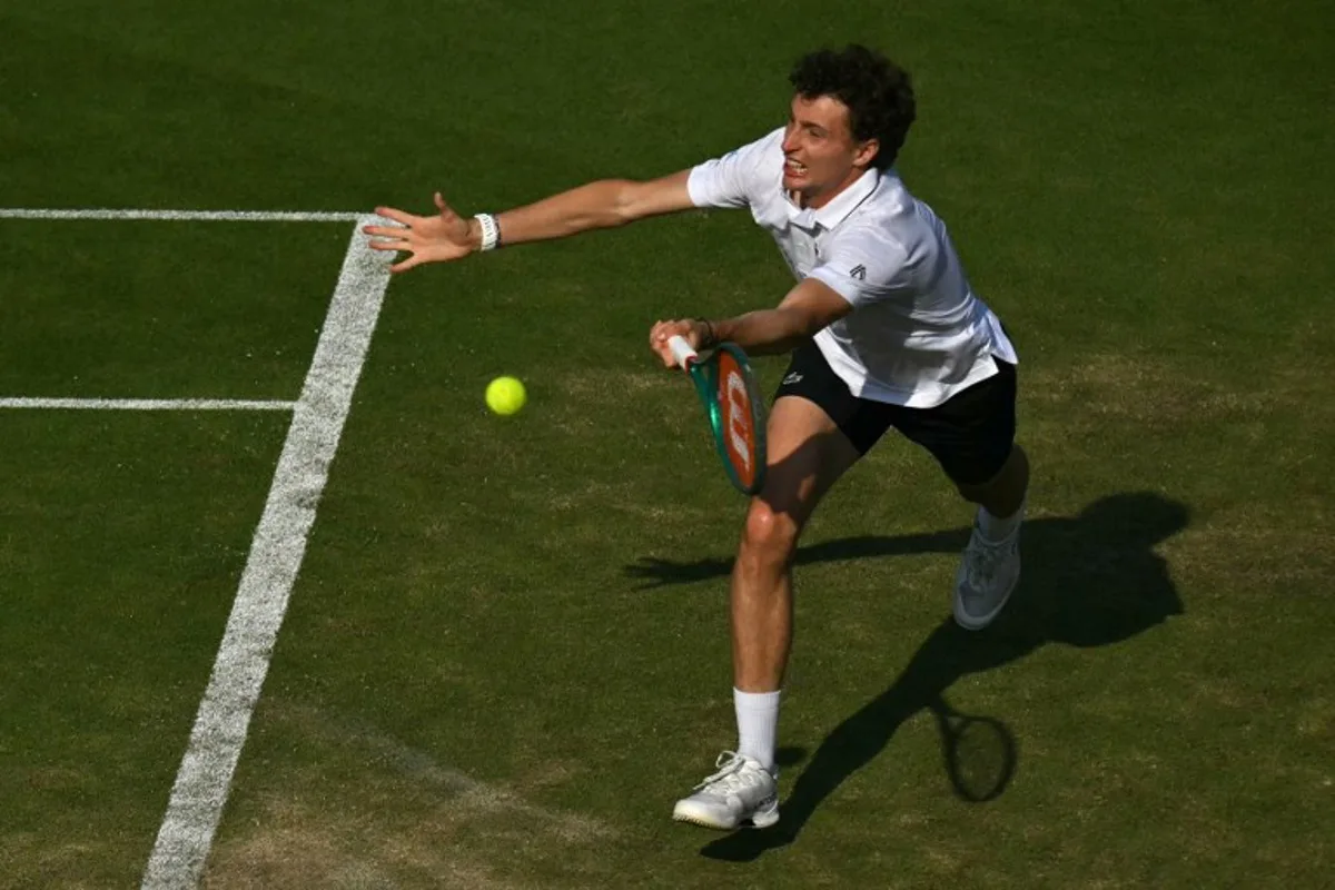 France's Ugo Humbert returns against Britain's Jack Draper during their men's semi-final tennis match on day five of the Lexus Eastbourne Open at Devonshire Park, Eastbourne, on the south coast of England on June 26, 2026.  Glyn KIRK / AFP