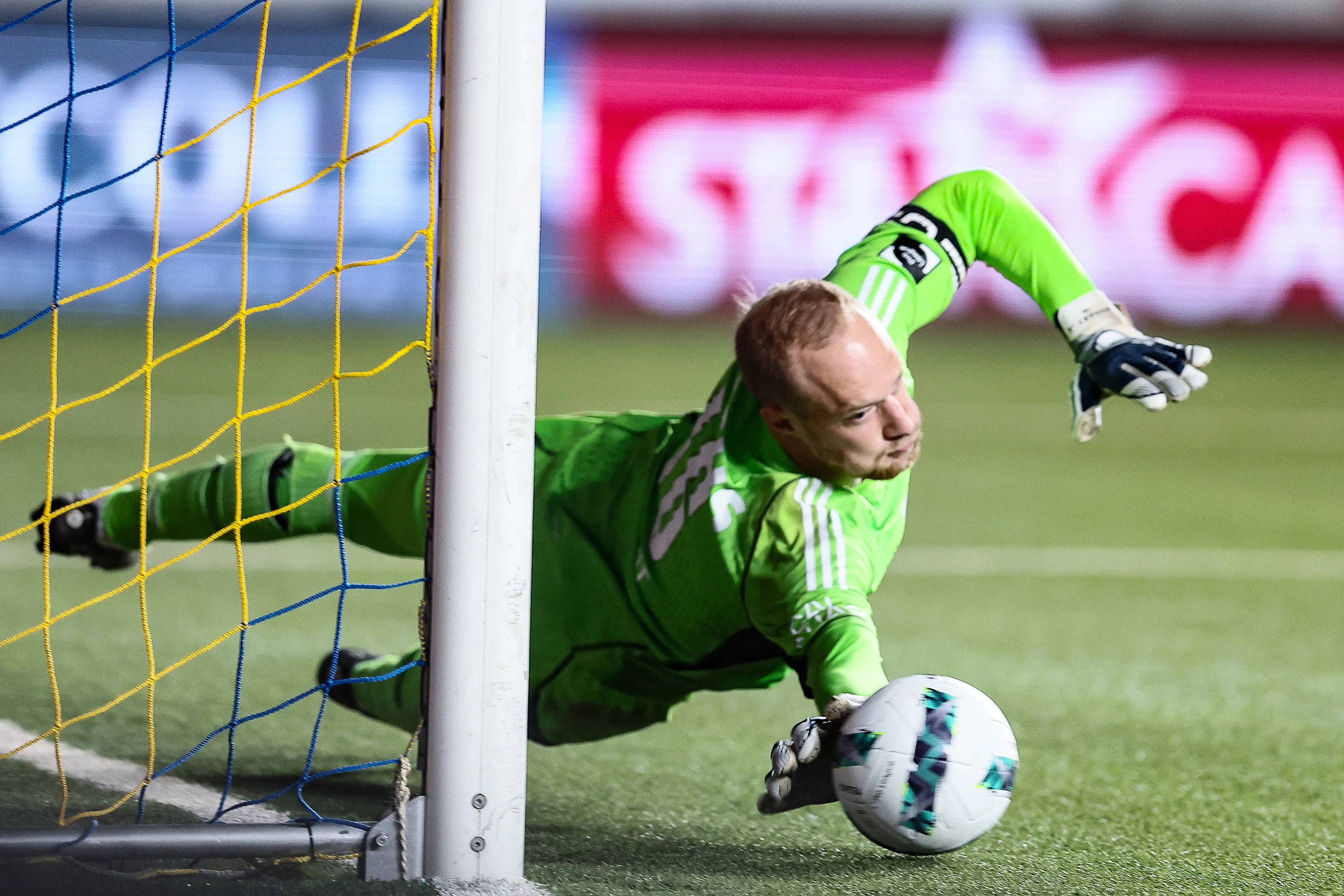 Standard's goalkeeper Arnaud Bodart stops the ball during a soccer match between Sint-Truidense VV and Standard de Liege, Friday 12 April 2024 in Sint-Truiden, on day 3 (out of 10) of the Europe Play-offs of the 2023-2024 'Jupiler Pro League' first division of the Belgian championship. BELGA PHOTO BRUNO FAHY