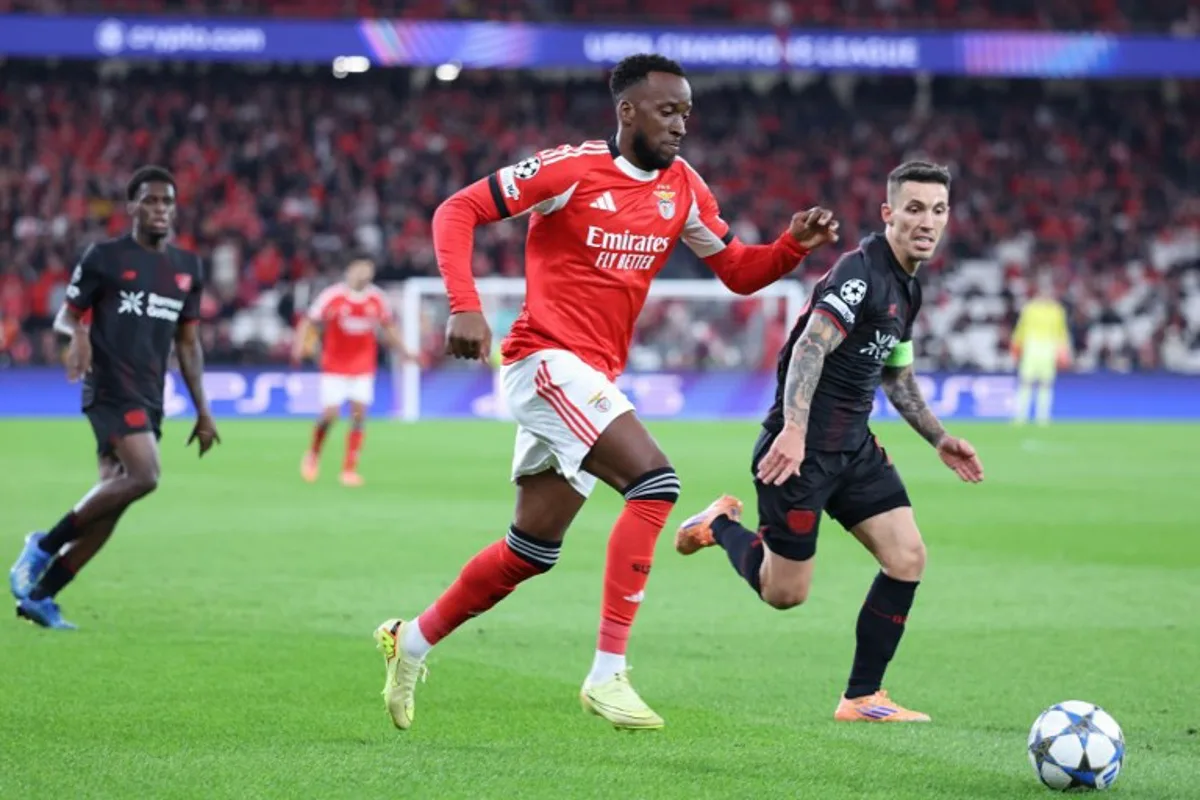 SL Benfica's Belgian forward #11 Dodi Lukebakio and Bayer Leverkusen's Spanish defender #20 Alejandro Grimaldo (R) vie for the ball during the UEFA Champions League league phase day 4 football match between SL Benfica and Bayer Leverkusen at Estadio da Luz in Lisbon on November 5, 2025. PATRICIA DE MELO MOREIRA / AFP