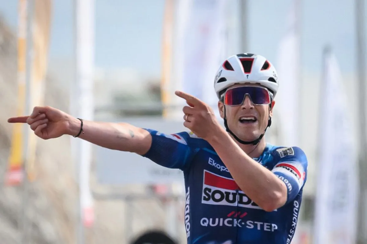 Soudal Quick-Step team's belgian rider Louis Vervaeke celebrates while crossing the finish line to win the second stage from Al Rustaq fort to Yitti Hills, of the Tour of Oman cycling race, on February 9, 2025. Loic VENANCE / AFP