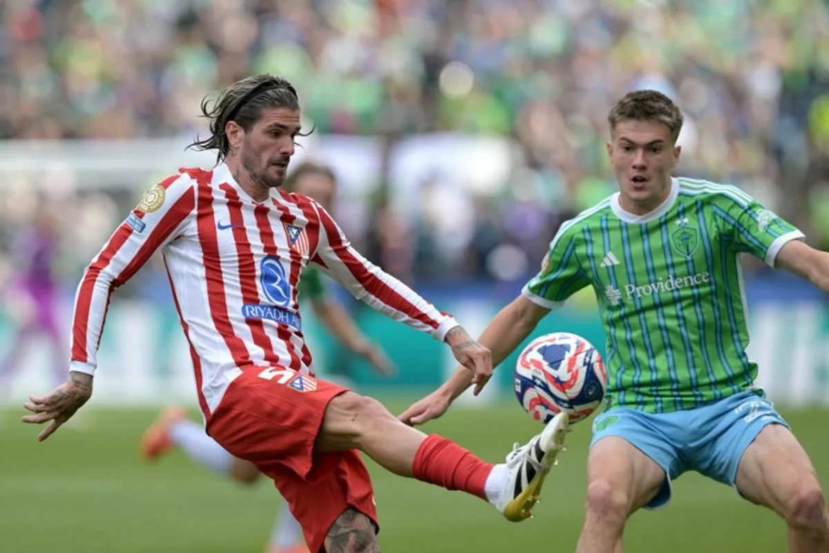 Atletico Madrid's Argentine midfielder #05 Rodrigo De Paul and Seattle Sounders' US midfielder #21 Reed Baker-Whiting fight for the ball during the FIFA Club World Cup 2025 Group B football match between US Seattle Sounders and Spain's Atletico de Madrid at the Lumen Field stadium in Seattle on June 19, 2025.  JUAN MABROMATA / AFP