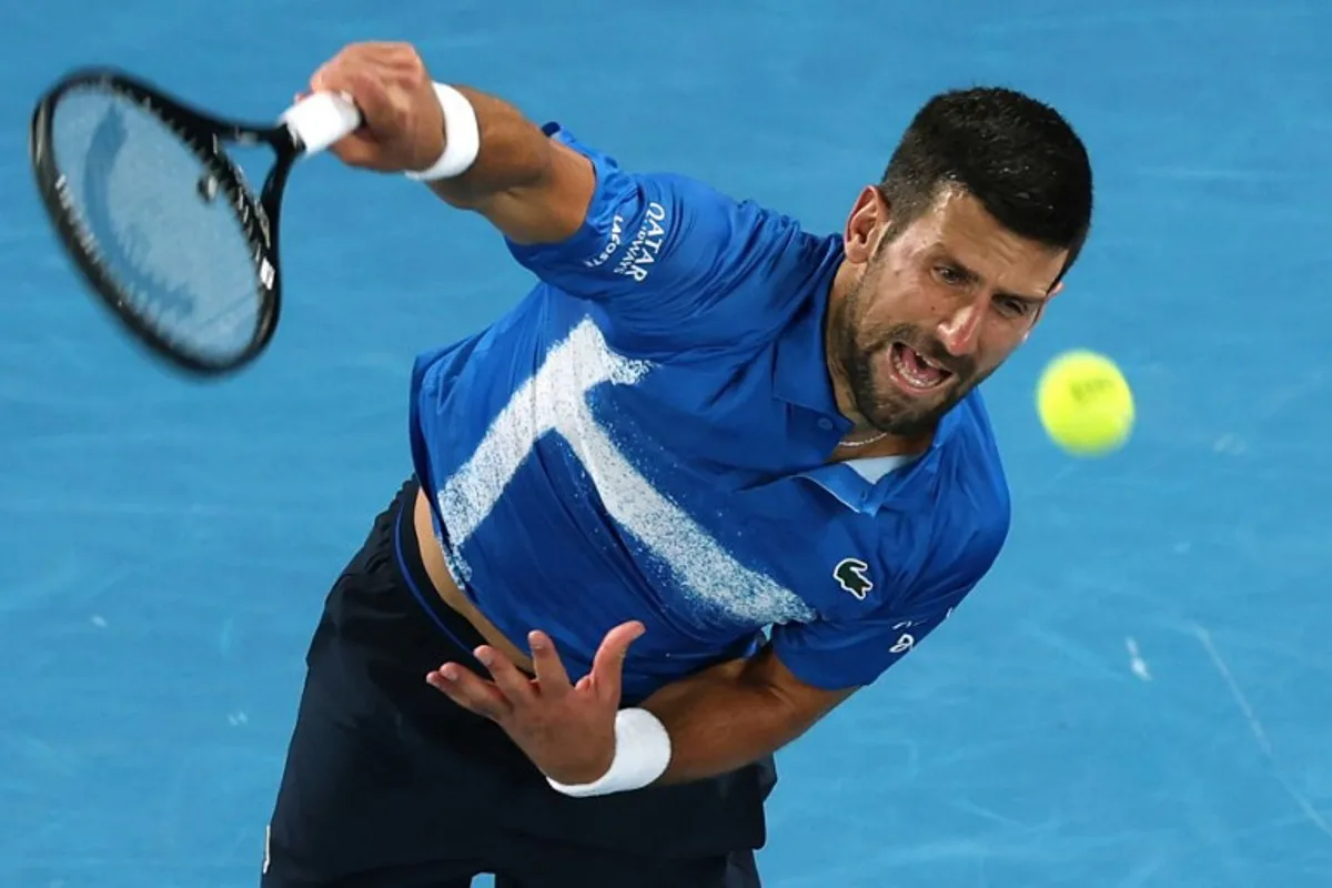 Serbia's Novak Djokovic serves against USA's Nishesh Basavareddy during their men's singles match on day two of the Australian Open tennis tournament in Melbourne on January 13, 2025.  Adrian DENNIS / AFP