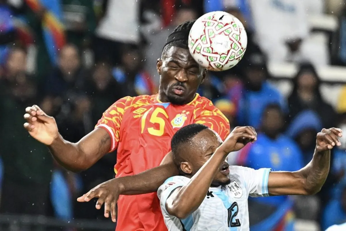 Democratic Republic Of Congo's defender #15 Rocky Bushiri and Botswana's defender #12 Mothusi Johnson vie during the Africa Cup of Nations (CAN) Group D football match between Botswana and Democratic Republic of Congo at El Madina Stadium in Rabat on December 30, 2025. SEBASTIEN BOZON / AFP