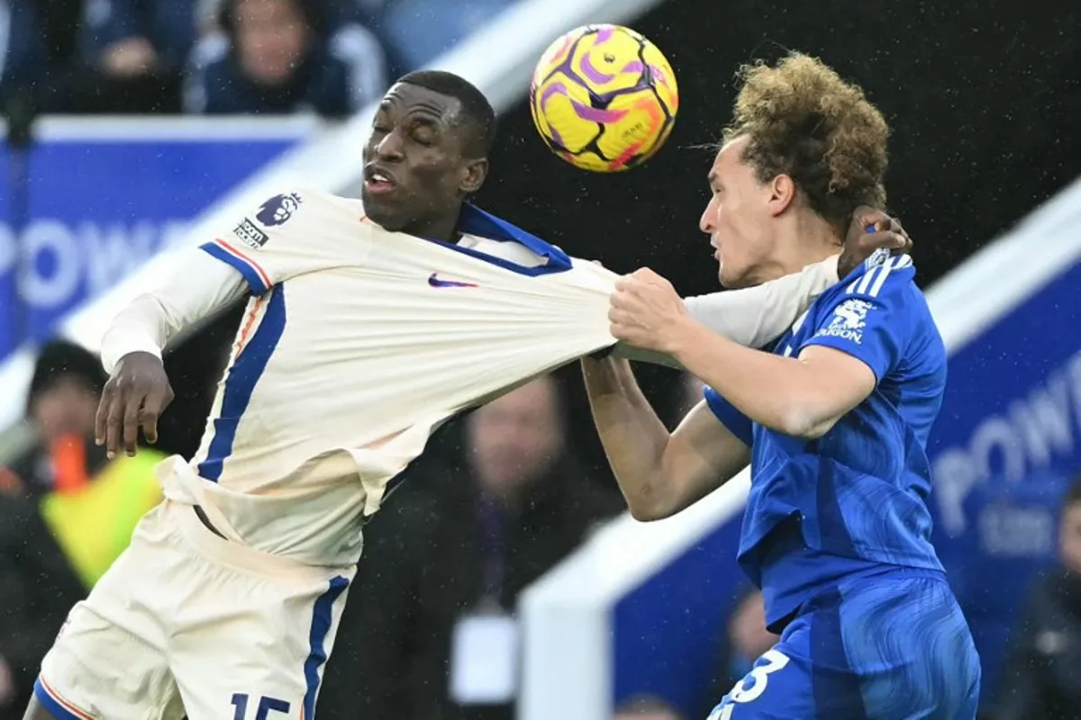 Chelsea's Senegalese striker #15 Nicolas Jackson (L) vies with Leicester City's Belgian defender #03 Wout Faes (R) during the English Premier League football match between Leicester City and Chelsea at King Power Stadium in Leicester, central England on November 23, 2024.  JUSTIN TALLIS / AFP