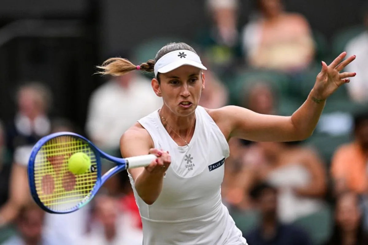 Belgium's Elise Mertens plays a forehand return to Belarus's Aryna Sabalenka during their women's singles fourth round tennis match on the seventh day of the 2025 Wimbledon Championships at The All England Lawn Tennis and Croquet Club in Wimbledon, southwest London, on July 6, 2025. Kirill KUDRYAVTSEV / AFP