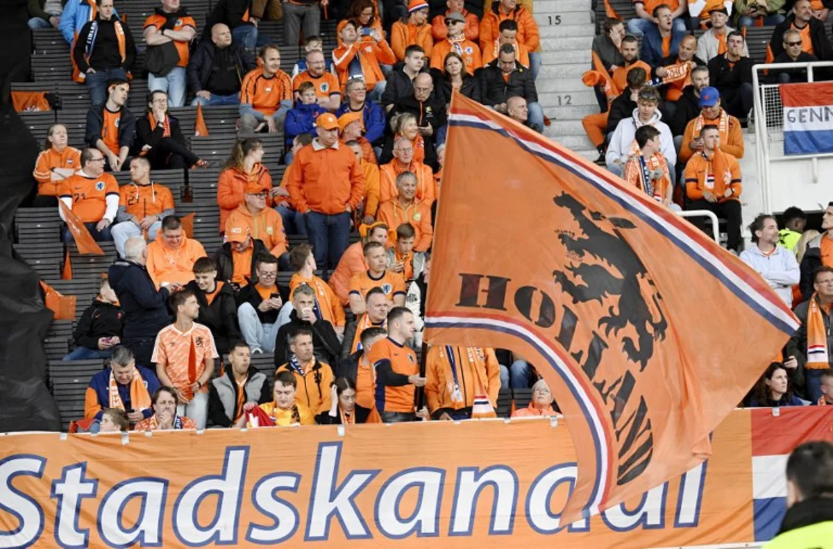 Fans of the Netherlands wave a giant flag prior to the 2026 FIFA World Cup Qualifying Group G football match between Finland and the Netherlands in Helsinki on June 7, 2025. Markku Ulander / LEHTIKUVA / AFP
