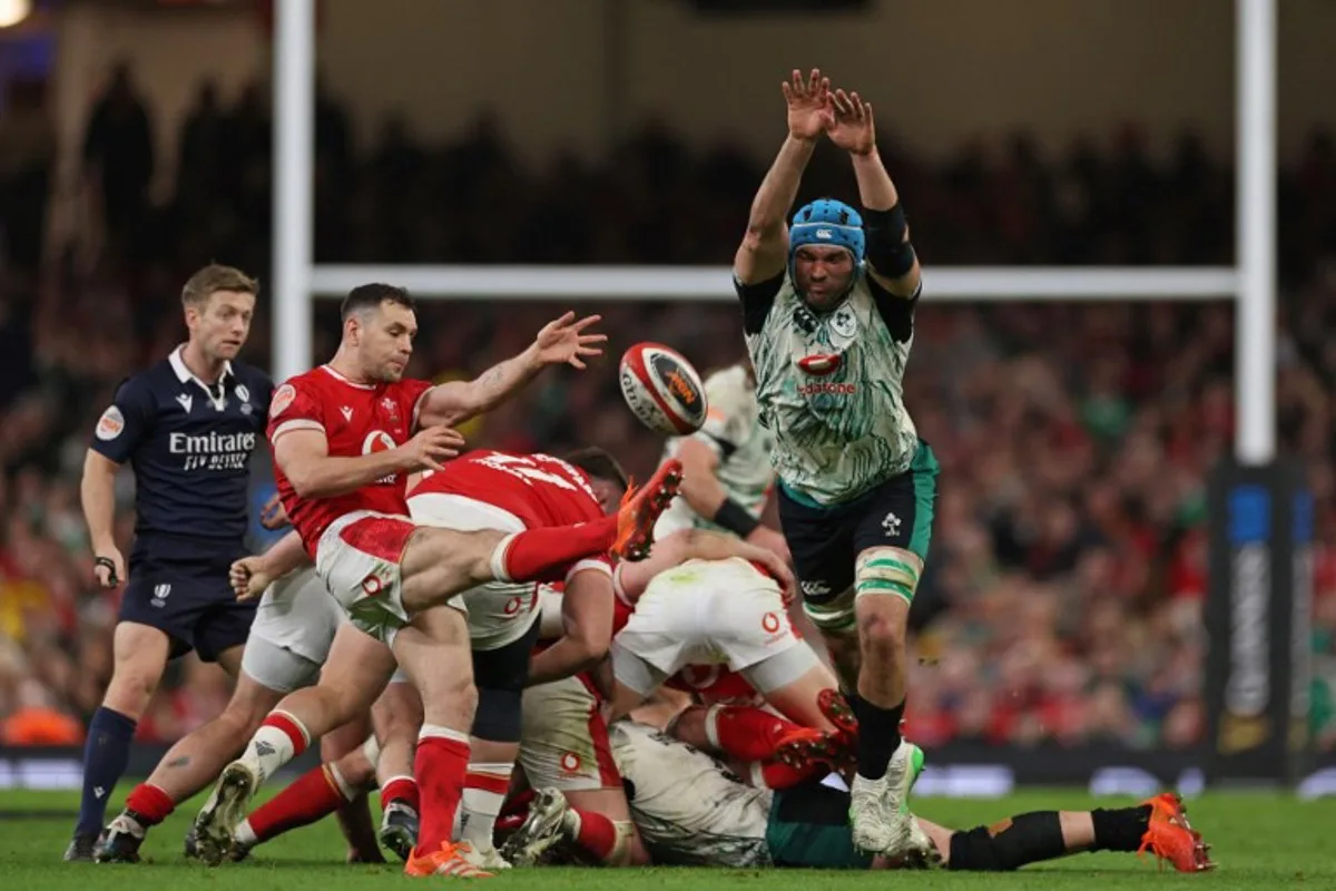 Ireland's lock Tadhg Beirne (R) attempts to charge down a kick by Wales' scrum-half Tomos Williams (L) during the Six Nations international rugby union match between Wales and Ireland at the Principality Stadium in Cardiff, south Wales, on February 22, 2025.  Adrian Dennis / AFP