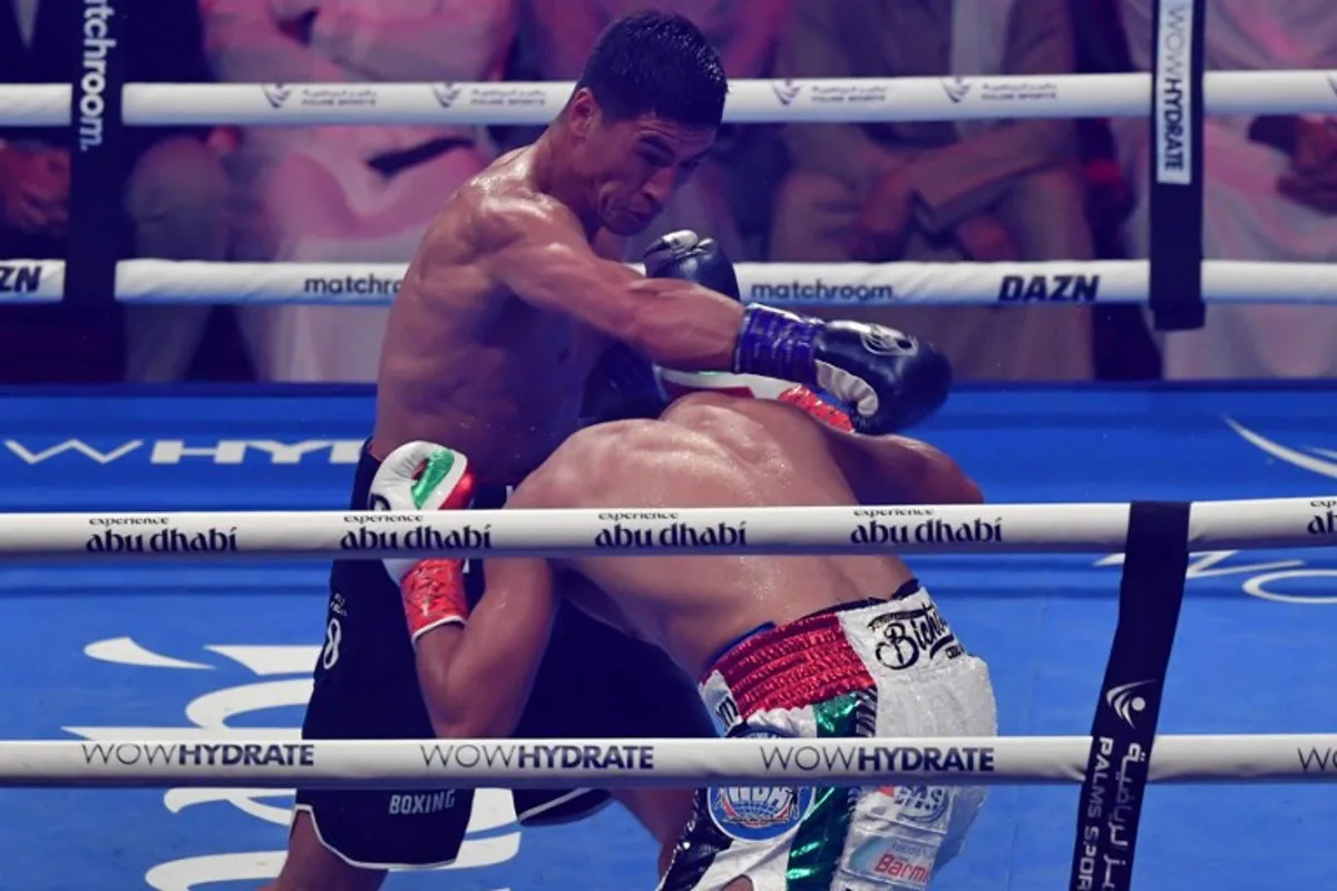 Dmitry Bivol (L) competes with Gilberto Ramirez during their WBA Light-Heavyweight World Title boxing match at the Etihad Arena in Abu Dhabi on November 5, 2022.  Ryan LIM / AFP