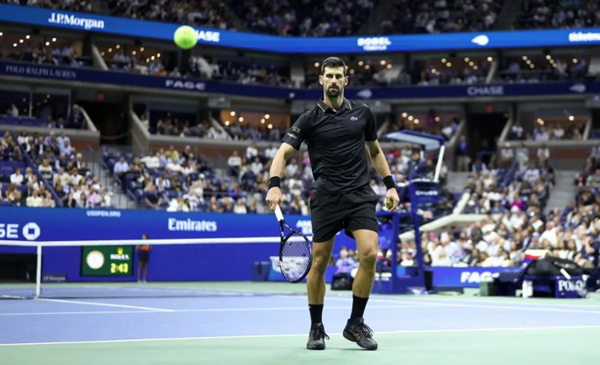 Serbia's Novak Djokovic eyes the ball during the men's singles quarterfinal tennis match against USA's Taylor Fritz on day ten of the US Open tennis tournament at the USTA Billie Jean King National Tennis Center in New York City, on September 2, 2025. CHARLY TRIBALLEAU / AFP