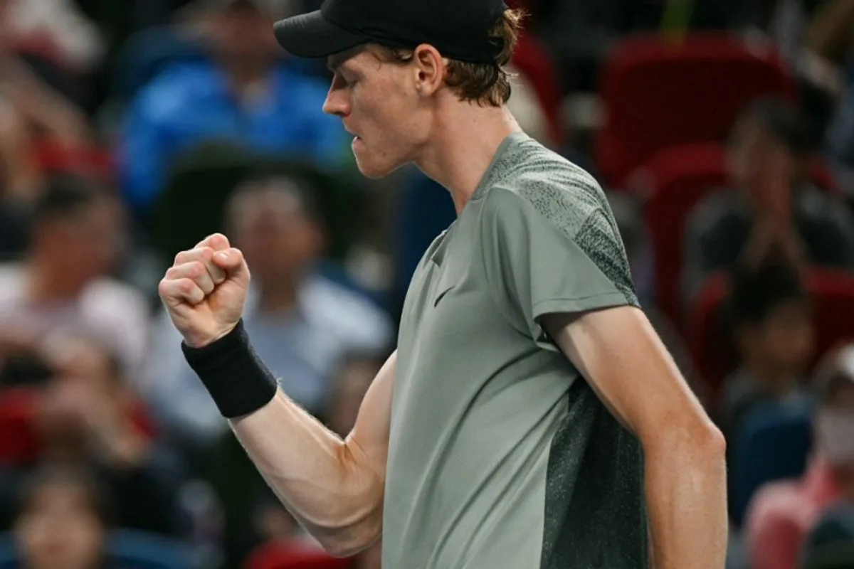 Italy's Jannik Sinner reacts after a point against Serbia's Novak Djokovic during their men's singles final match at the Shanghai Masters tennis tournament in Shanghai on October 13, 2024.  HECTOR RETAMAL / AFP