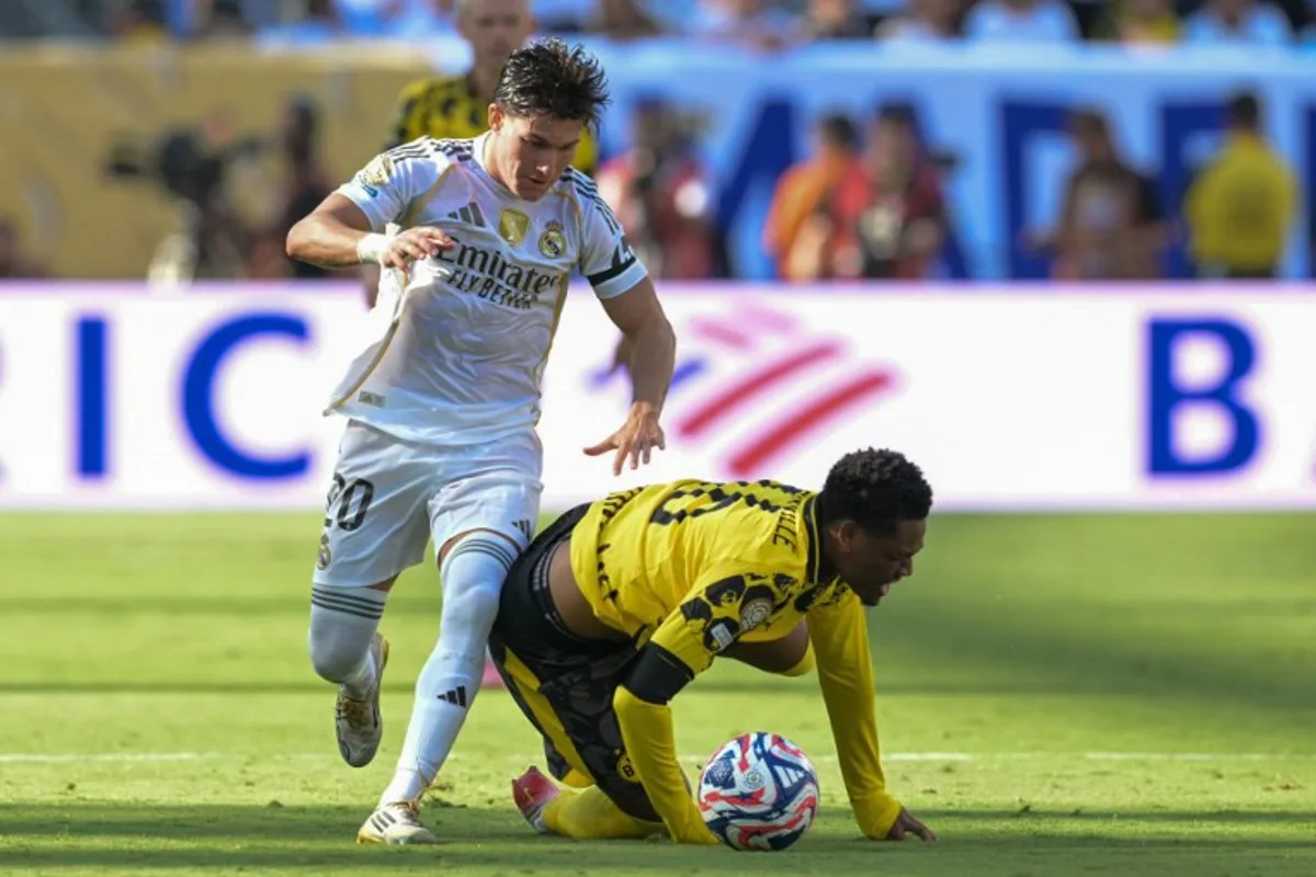 Real Madrid's Spanish defender #20 Francisco Garcia and Borussia Dortmund's Belgian forward #16 Julien Duranville fight for the ball during the FIFA Club World Cup 2025 quarterfinal football match between Spain's Real Madrid and Germany's Borussia Dortmund at the MetLife stadium in East Rutherford, New Jersey on July 5, 2025. JUAN MABROMATA / AFP