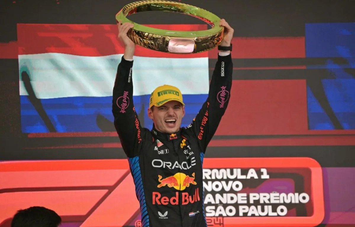 Red Bull Racing's Dutch driver Max Verstappen celebrates at the podium with the trophy of the Formula One Sao Paulo Grand Prix, at the Jose Carlos Pace racetrack, aka Interlagos, in Sao Paulo, Brazil, on November 3, 2024.  NELSON ALMEIDA / AFP