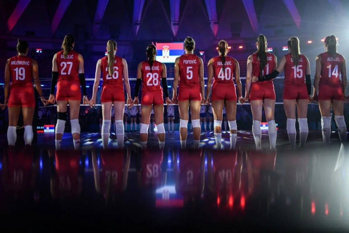 Serbia's players hold hands as they listen to their national anthem at the start of the 2025 Women's Volleyball World Championship pool match between Serbia and Ukraine at Huamark Indoor Stadium in Bangkok on August 23, 2025. Amaury PAUL / AFP