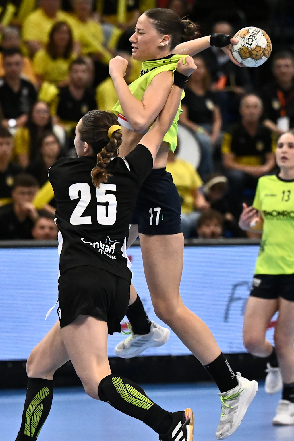 HC Sprimont's Charline Dehousse and HB Sint-Truiden's Marie Carabin fight for the ball during a handball game between HC Sprimont and HB Sint-Truiden, Saturday 19 April 2025, in Hasselt, the women's final of the Belgian handball cup. BELGA PHOTO JOHAN EYCKENS