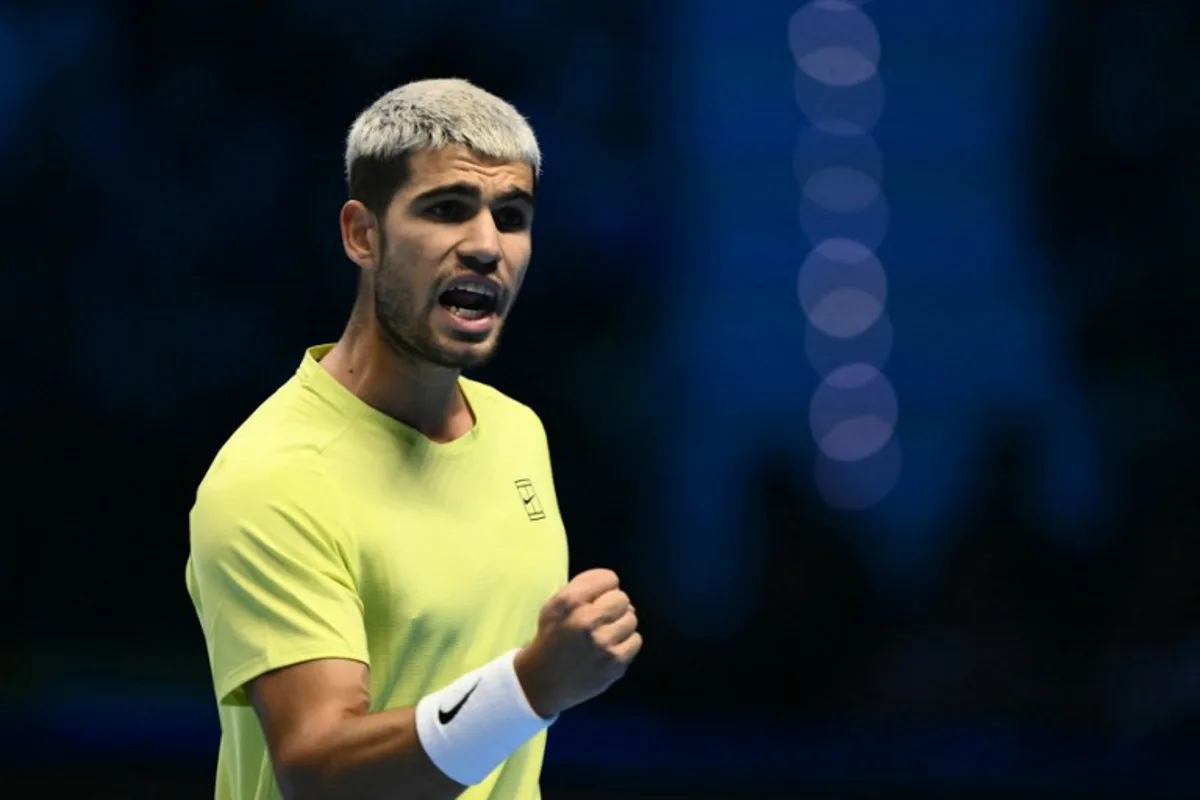 Spain's Carlos Alcaraz reacts during his semifinal match against Canada's Felix Auger-Aliassime at the ATP Finals tennis tournament in Turin on November 15, 2025. Marco BERTORELLO / AFP