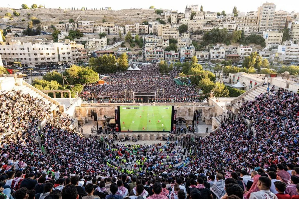 Jordanian football fans gather to watch on giant screens their national team's 2026 World Cup Group J football match against Algeria at Amman's 2nd-century Roman amphitheatre early on June 23, 2026. George SAIF / AFP