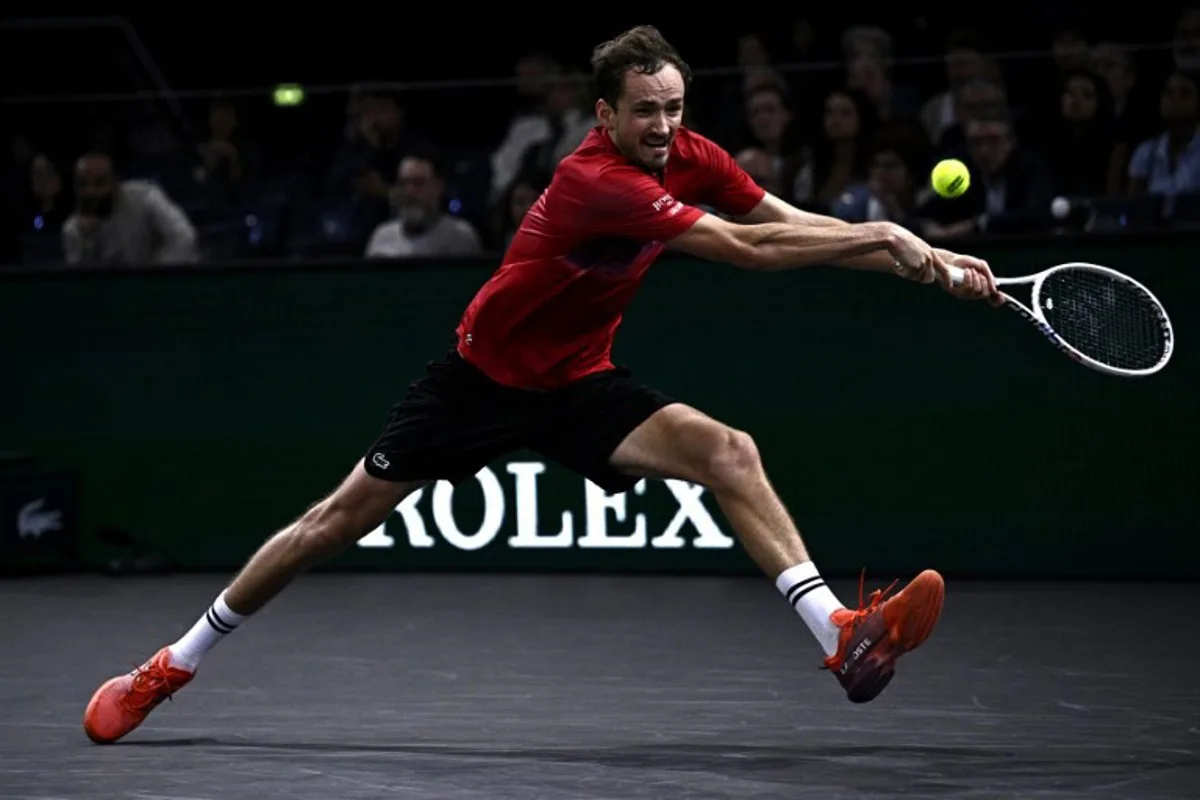 Russia's Daniil Medvedev plays a backhand return to Australia's Alexei Popyrin during their men's singles match on day three of the Paris ATP Masters 1000 tennis tournament at the Accor Arena - Palais Omnisports de Paris-Bercy - in Paris on October 30, 2024.  JULIEN DE ROSA / AFP