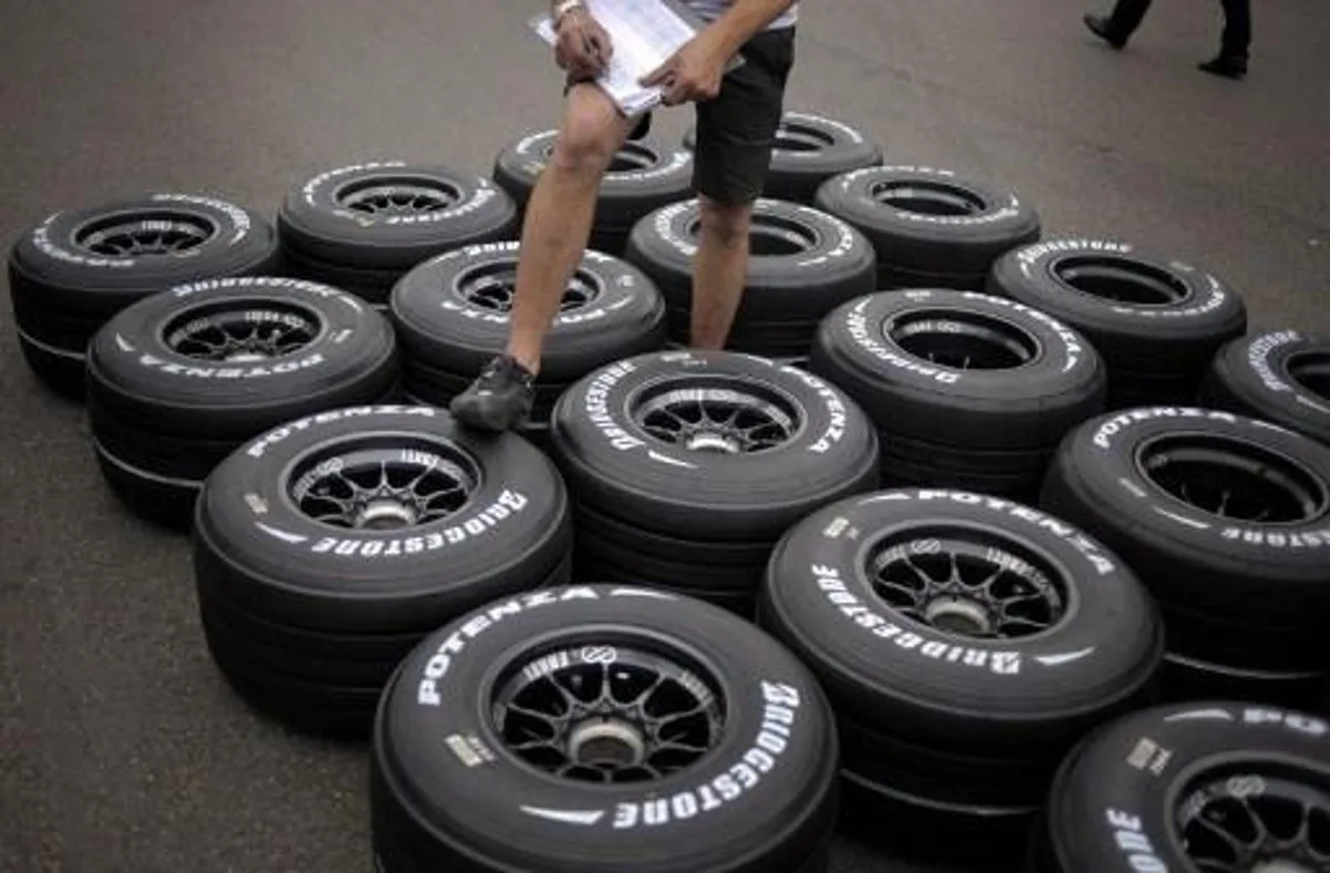 A technician cheks tires in the paddock of the Magny-Cours racetrack on June 19, 2008 in Magny-Cours, central France, three days ahead of the French Formula One Grand Prix. AFP PHOTO / JEFF PACHOUD
