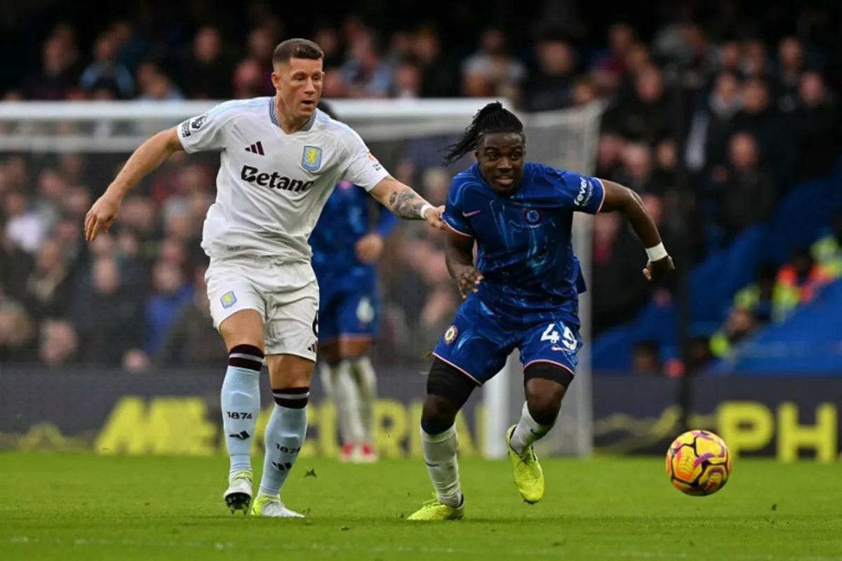 Chelsea's Belgian midfielder #45 Romeo Lavia runs with the ball from Aston Villa's English defender #06 Ross Barkley during the English Premier League football match between Chelsea and Aston Villa at Stamford Bridge in London on December 1, 2024.  Glyn KIRK / AFP