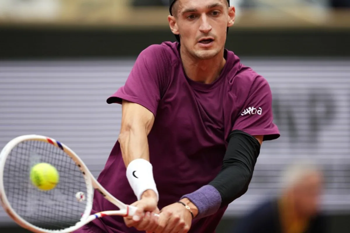 France's Terence Atmane plays a backhand return to France's Richard Gasquet during their men's singles match on day 2 of the French Open tennis tournament on Court Philippe-Chatrier at the Roland-Garros Complex in Paris on May 26, 2025. Dimitar DILKOFF / AFP