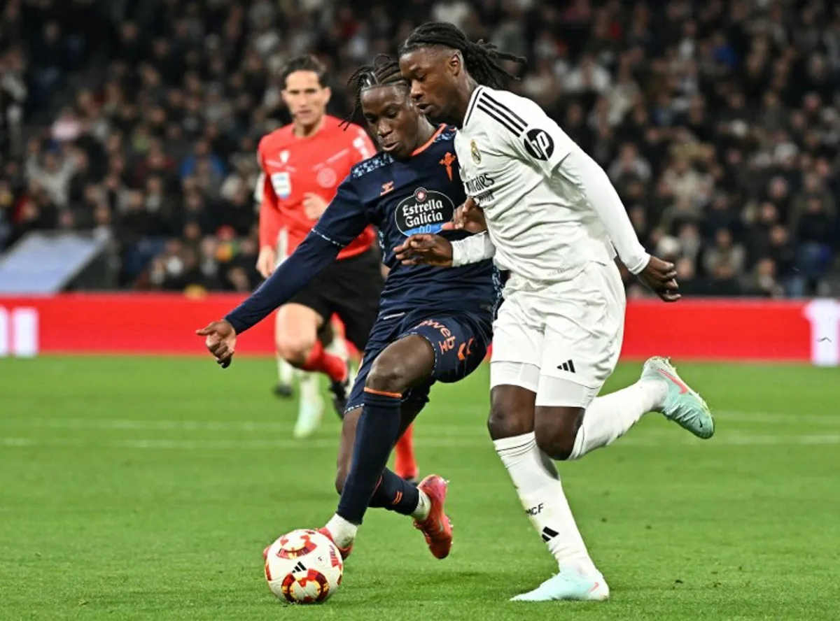 Real Madrid's French midfielder #06 Eduardo Camavinga fights for the ball with Celta Vigo's Guinean midfielder #06 Ilaix Moriba during the Spanish Copa del Rey (King's Cup) last 16 first leg football match between Real Madrid CF and RC Celta de Vigo at the Santiago Bernabeu stadium in Madrid on January 16, 2025.  JAVIER SORIANO / AFP