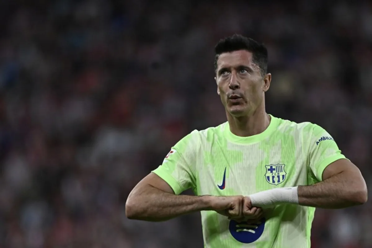 Barcelona's Polish forward #09 Robert Lewandowski celebrates scoring his second goal during the Spanish league football match between Athletic Club Bilbao and FC Barcelona at San Mames Stadium in Bilbao, on May 25, 2025. ANDER GILLENEA / AFP