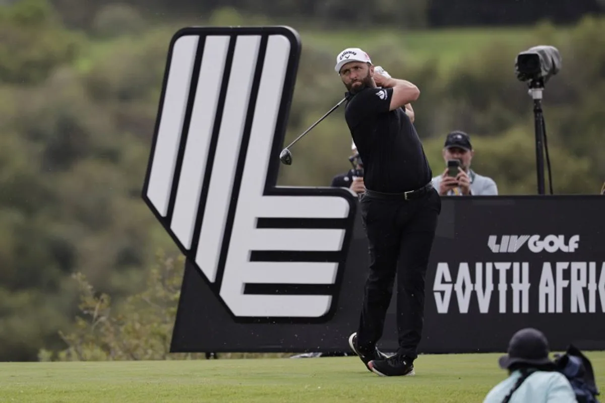 Legion XIII's Spanish player Jon Rahm watches a drive from the 14th tee on the fourth day of the LIV Golf South Africa tournament at The Club in Steyn City on March 22, 2026.  WIKUS DE WET / AFP