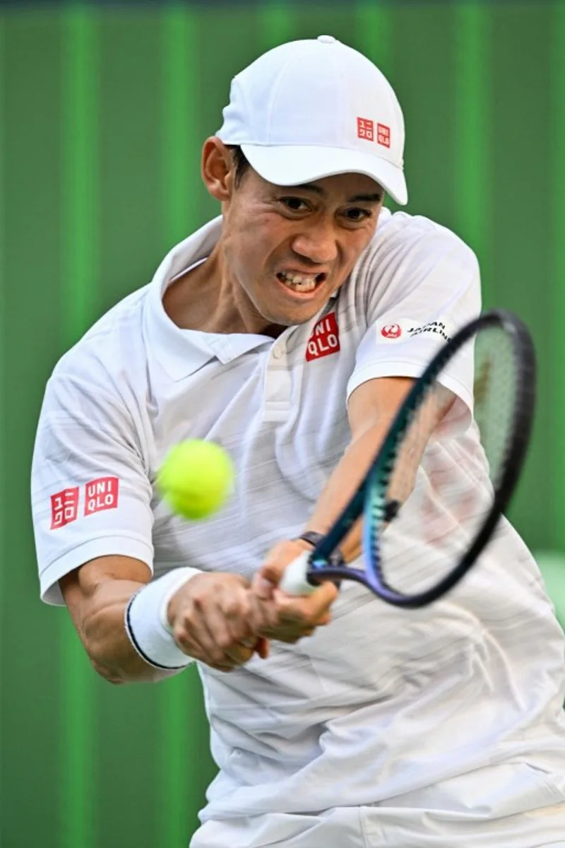 Japan's Kei Nishikori hits a return to Greece's Stefanos Tsitsipas during their men's singles match at the Shanghai Masters tennis tournament in Shanghai on October 4, 2024.  Hector RETAMAL / AFP